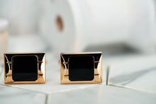 An image of two sophisticated rose gold cufflinks that have a black square center; made by Dear Martian, Brooklyn.