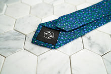 The back of the Dear Martian, Ditsy skinny floral purple tie, featuring a hexagon DM stitched logo.