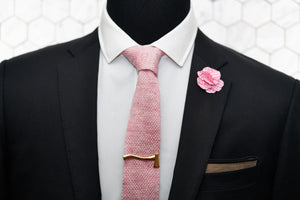 Dear Martian's pink linen tie featured on a mannequin wearing the Kloven gold axe tie clip as well as a gingham floral lapel pin and our brown linen pocket square.