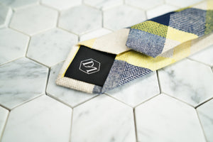 An image of the back of the Flatbush skinny linen blended tie, which features Dear Martian's hex logo.