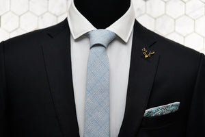 A dapper display of the Dear Martian, Tiffany blue blended tie paired with the Whitman pocket square and gold stag lapel pin.