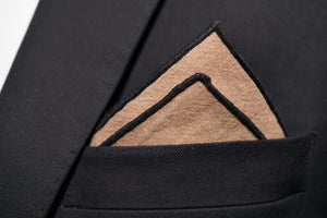 An image of Dear Martians latte slub Linen pocket square shown with a two-point fold.