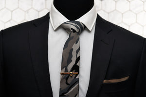 An image showing how Dear Martian's Fort Hamilton tie can be paired up with other men's accessories such as the Vie gold skull tie clip and Arbuckle brown linen pocket square.