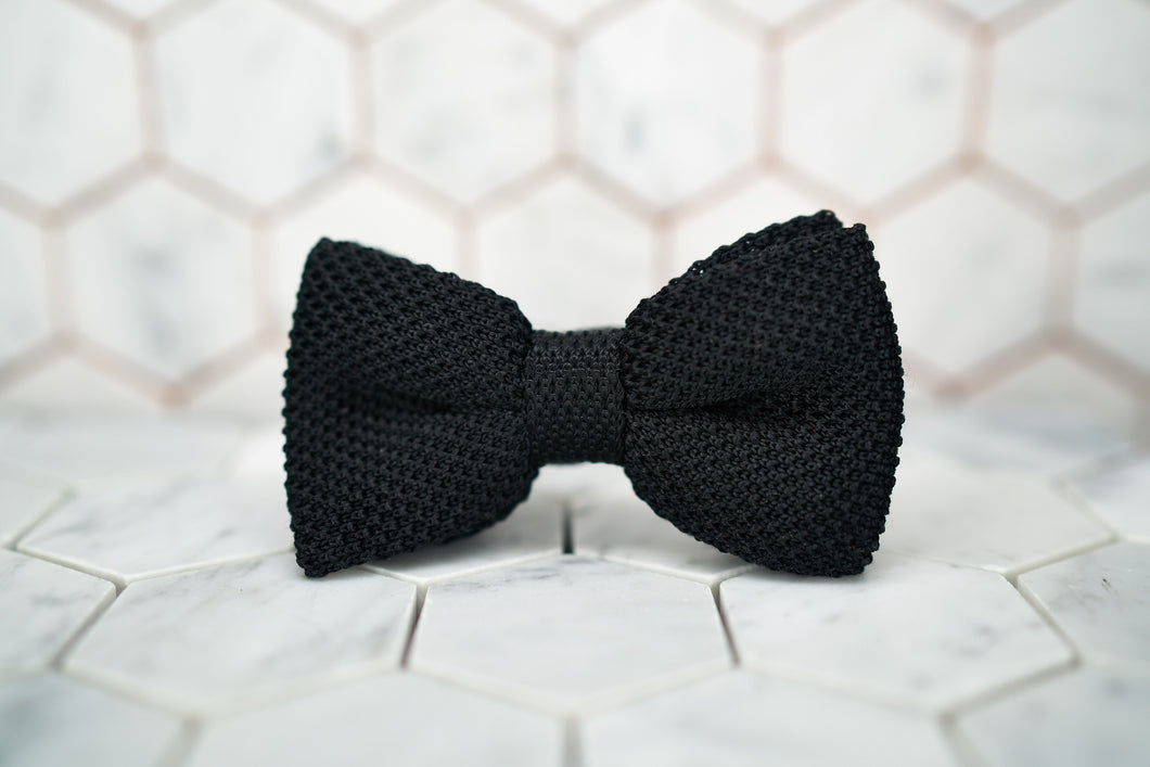 The front image of the Dear Martian, silk knitted bow tie, sitting upon a hexagonal white background.