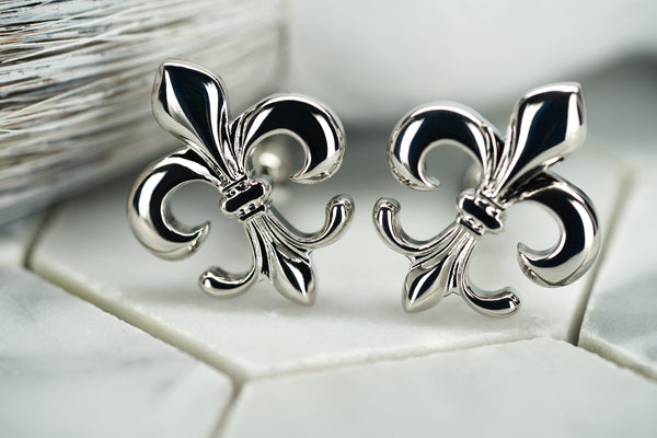 A product image featuring the silver pair of fleur de lis cufflinks by Dear Martian, named Carroll.