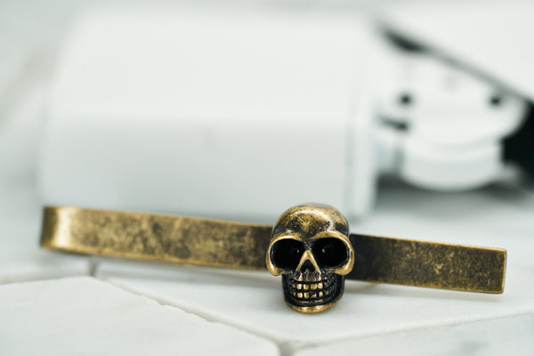 A product image of the vintage gold Vie skull tie bar by Dear Martian.