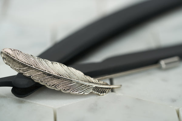 A front image of the antique silver feather lapel pin by Dear Martian, Brooklyn.