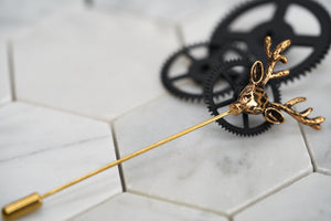 An image of an antique gold stag lapel pin by Dear Martian, Brooklyn. 