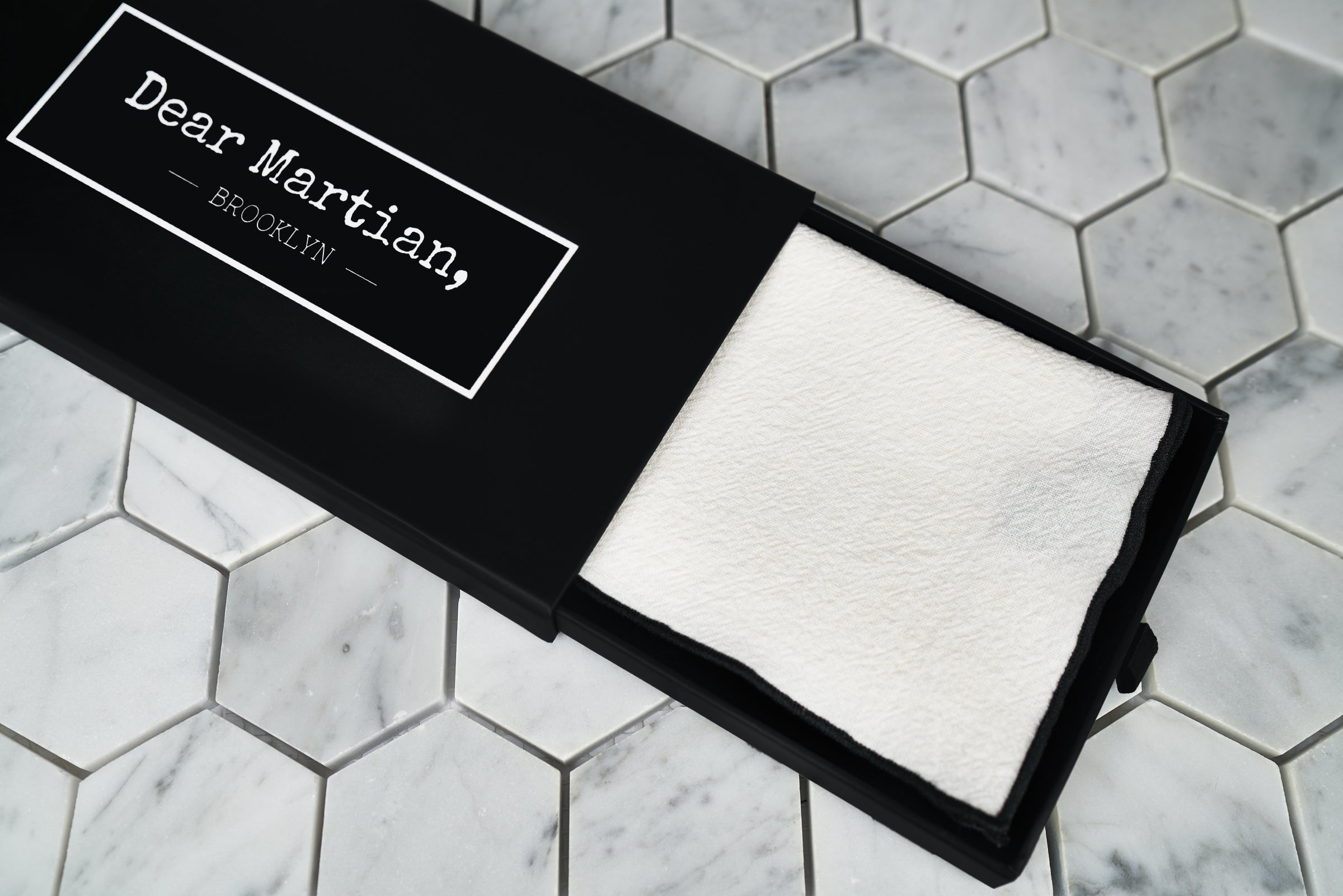 An image of our Al Pacino white linen pocketsquare inside our signature Dear Martian black box.