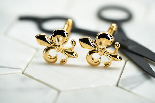 The front image of Dear Martian's gold plated fleur de lis cufflinks for men.