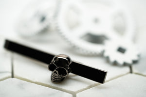 An image of a gunmetal mens skull tie bar by Dear Martian, BKYLN.