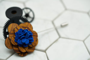 A front view of Dear Martian's suit accessory; the handmade wood lapel pin.