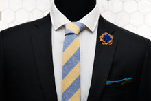 A mannequin is dressed in Dear Martian's menswear; a yellow striped linen necktie , floral pocket square, and wooden flower lapel pin.