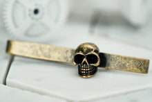 A side view image of the rustic brass skull tie clip by Dear Martian, Brooklyn.