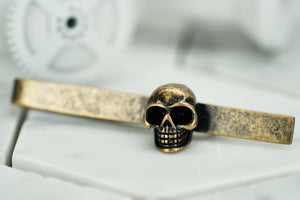 A side view image of the rustic brass skull tie clip by Dear Martian, Brooklyn.