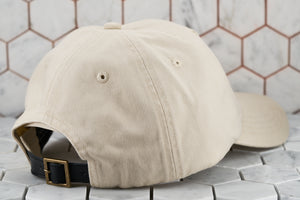 The back image of the minimal hex hat by Dear Martian in a khaki color. The back shows the belt buckle genuine leather strapback.