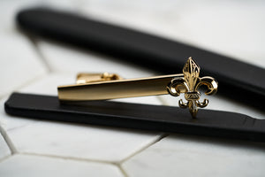 A front image of the DM Brooklyn gold plated flower of life tie clip for men.