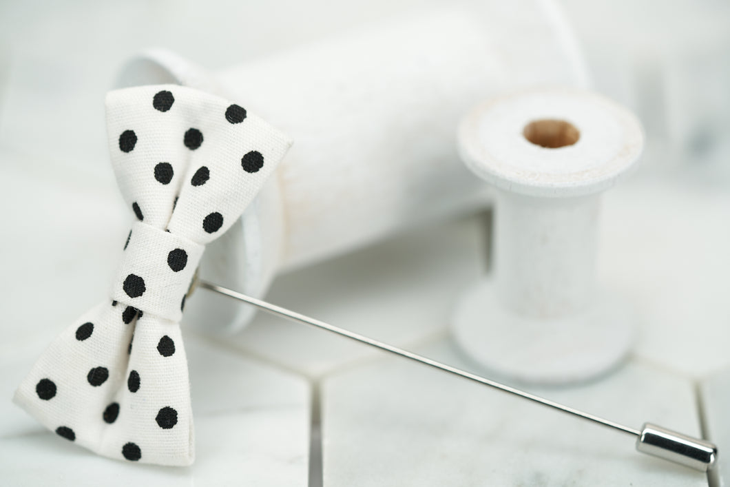 A side view image of the white and black polka dotted lapel pin; handmade by Dear Martian in Brooklyn, NYC.