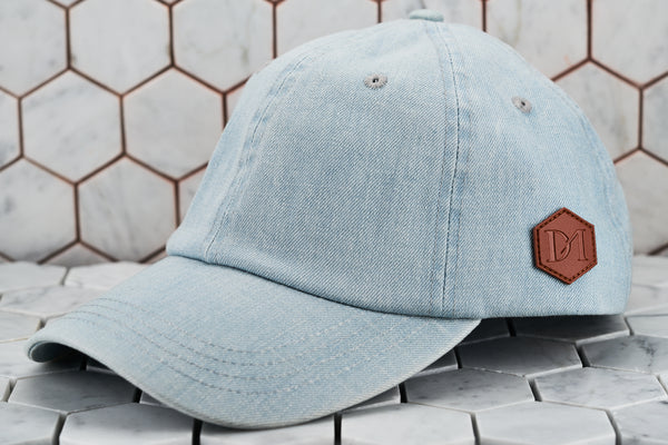 The front view image of the Dear Martian minimal dad hat, which features a brown leather patch on the side panel.