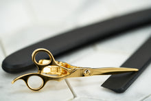 A side view image of the gold tone brass scissor tie bar by Dear Martian.