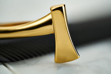 An up close image of the gold Dear Martian ax tie bar accessory for men.