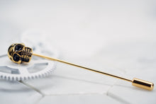 A side view image of the gold plated Vie skull tie clip made by Dear Martian, Brooklyn is laying against a white background.