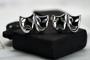 An image of a pair of steel plated theater mask cufflinks by Dear Martian.