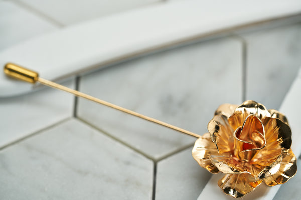 A side view image of the rose gold floral suit lapel pin by Dear Martian, Brooklyn.