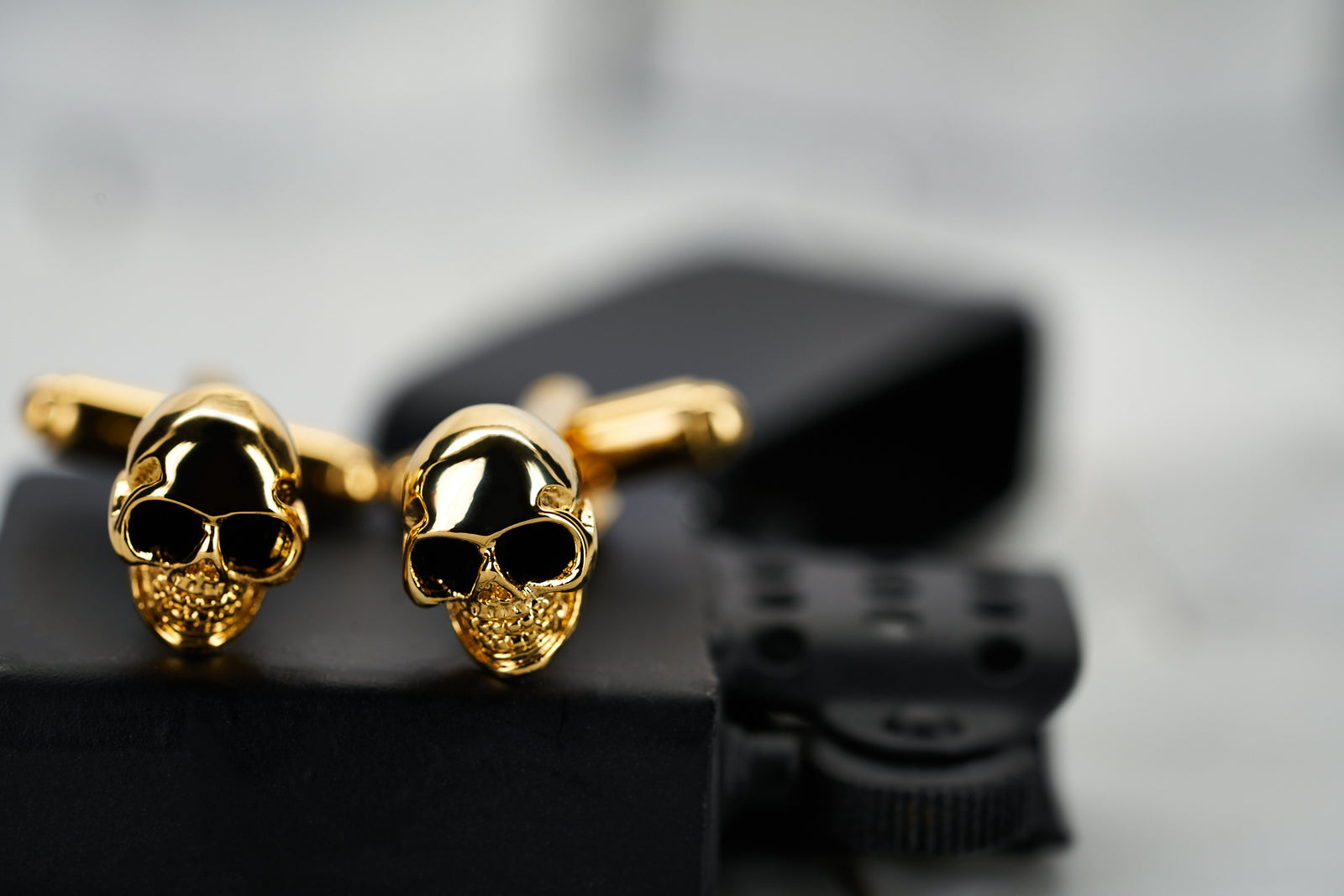 A front view image the gold plated skull men's cufflinks made by Dear Martian, Brooklyn.