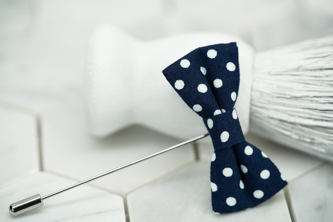 A product image of the navy and blue polka dot lapel pin for men by Dear Martian.