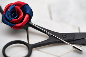 A side view image of the navy red twist flower lapel pin for him.