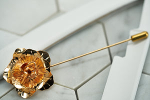 A front view image of the DM Brooklyn rose suit boutonniere pin. 