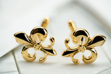 A front image of vintage gold tone brass fleur de lis cufflinks made by Dear Martian, Brooklyn.