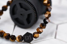 A detailed image of the energy bracelet strung with tigers eye stones.