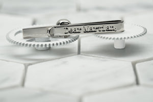 A back view image of the steel Vie skull tie bar, which features the Dear Martian logo etching.