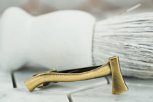 A side angle of the Dear Martian, Brooklyn, vintage brass ax tie clip.