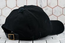 The back view of the distressed raw black dad hat by Dear Martian, Brooklyn; which depicts the leather strap.