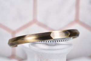 A side view image of the Duality bangle by Dear Martian Brooklyn, which shows the sleek stylish bezel of the cuff.