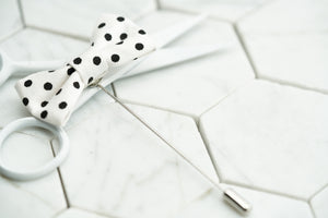 A top view image of the Dalmatian black and white spotted mini bow tie lapel pin by Dear Martian.