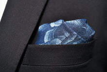 A black suit jacket pocket is stuffed with Dear Martian's Cranford rose denim pocket square. 