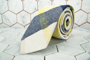 A handmade patterned necktie made by Dear Martian,  Brooklyn is rolled up.