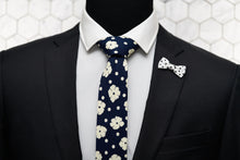 The Poplar indigo navy floral tie by Dear Martian, is paired with a matching polka dot bow shaped lapel pin.