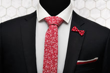 The Dear Martian, red floral tie is put on the mannequin; dressed in a black suit sporting a mini red bow lapel pin and our silk knitted red pocketsquare.