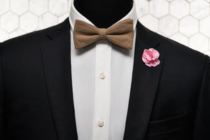 An image of a mannequin sporting our Dear Martian slub linen bow tie with a gingham pink patterned lapel pin.