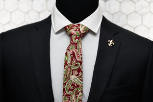 Our Dear Martian red cotton paisley tie is displayed on a mannequin with the Connors gold fleur de lis lapel pin.