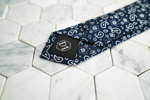 A product image of the back of the navy floral and paisley skinny tie exclusively handmade by Dear Martian, Brooklyn.