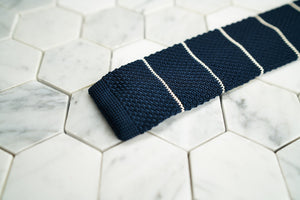 A detailed photo of Dear Martian's Roebling dark blue tie, which is white striped.