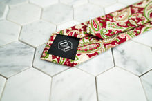 The back of the vibrant Connors paisley red neck tie from Dear Martian, features a DM stitched on the tie's tipping.