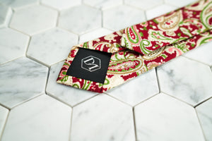 The back of the vibrant Connors paisley red neck tie from Dear Martian, features a DM stitched on the tie's tipping.