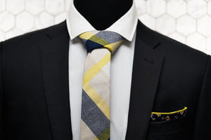 A men's black suit is paired with Dear Martian's collage patterned tie and floral pocket square.